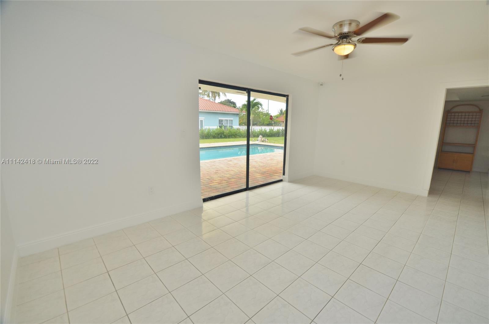 6760 Royal Melbourne Drive Hialeah, FL 33015 - Photo 33 of 36 wooden floor in an empty room with a window