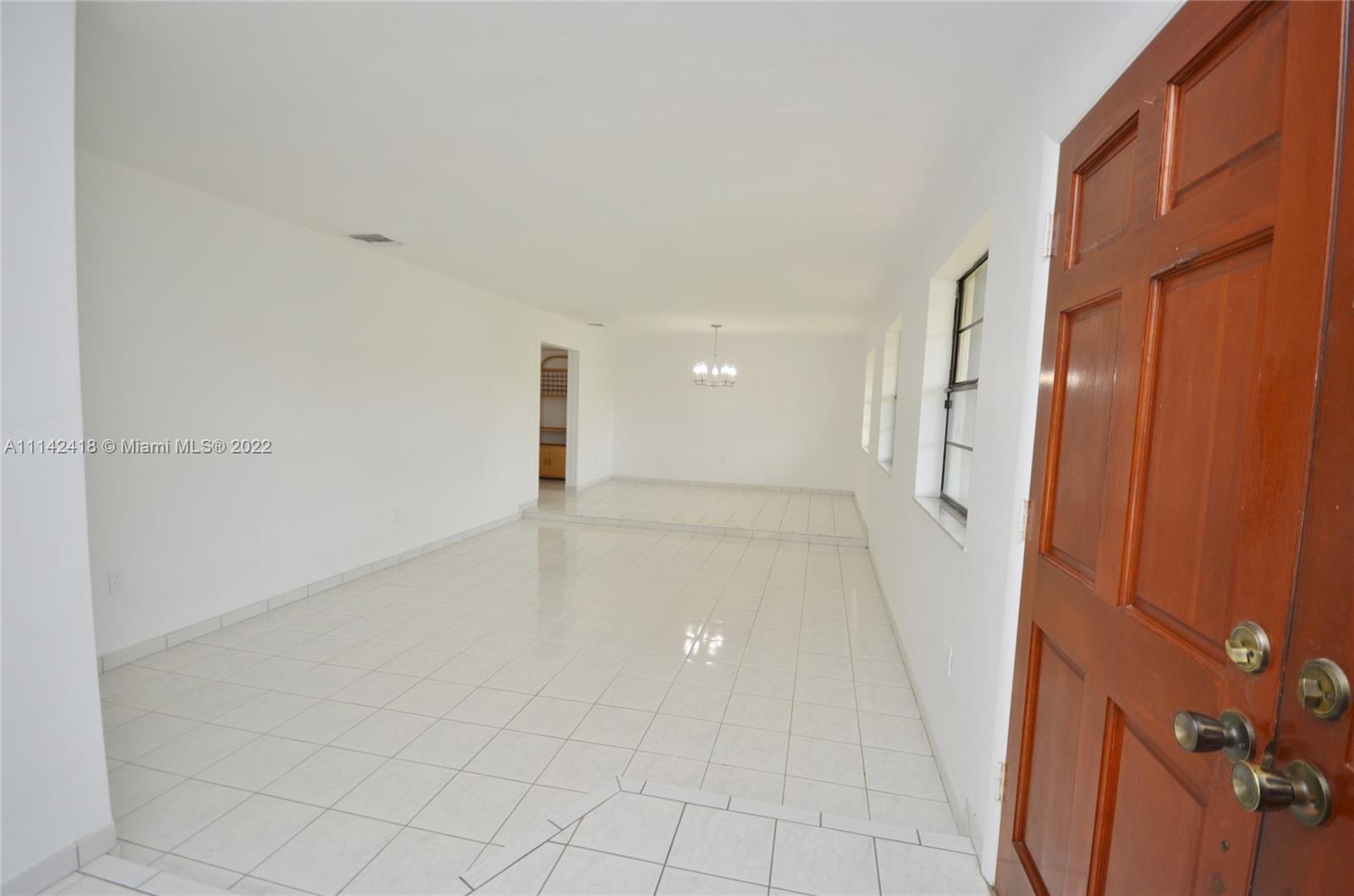 6760 Royal Melbourne Drive Hialeah, FL 33015 - Photo 35 of 36 a view of a hallway with closet