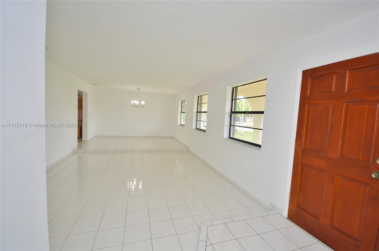 6760 Royal Melbourne Drive Hialeah, FL 33015 - Photo 36 of 36 a view of an empty room with windows and cabinet