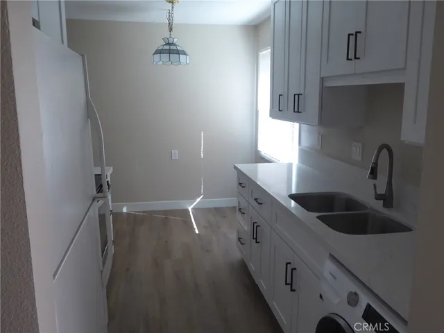 a kitchen with a sink and refrigerator