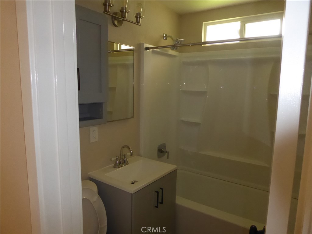 6641 Harley Street Riverside, CA 92506 - Photo 6 of 12 a bathroom with a sink a toilet and shower