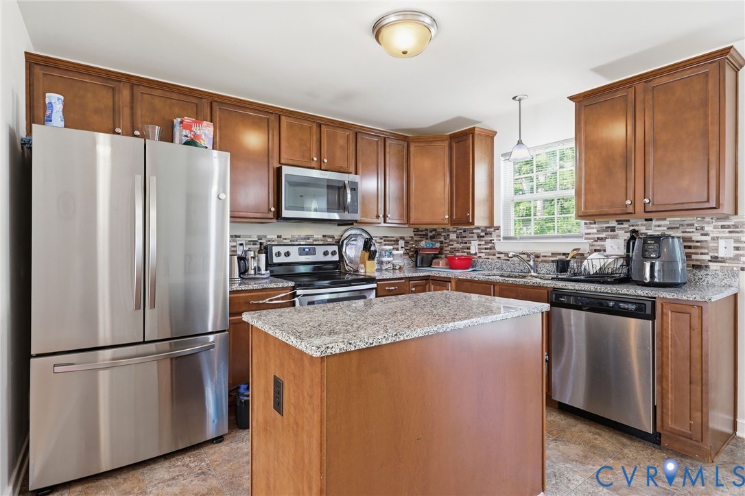 10155 Virginia Road Glen Allen, VA 23060 - Photo 3 of 50 Kitchen featuring a central island with a granite-