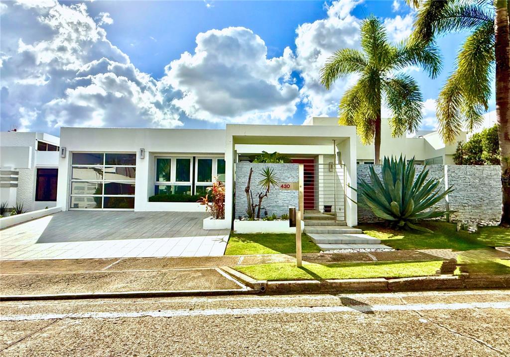 a view of a house with backyard and swimming pool