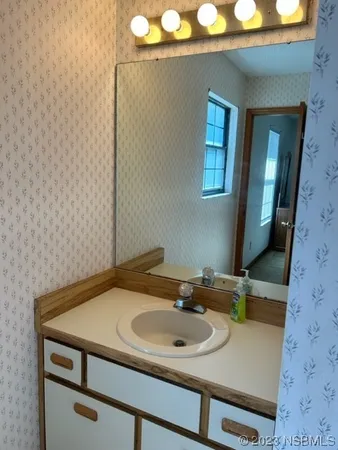 a bathroom with a sink and a mirror