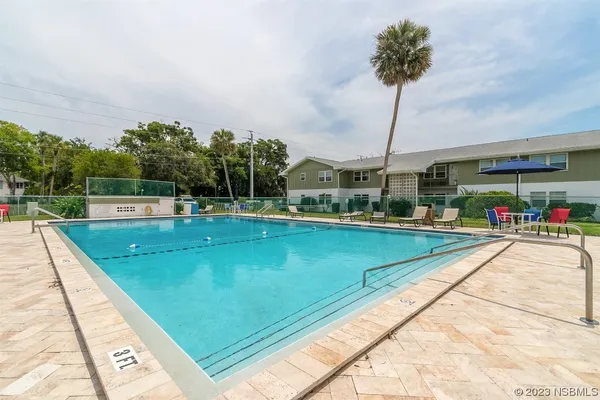a view of swimming pool with outdoor seating
