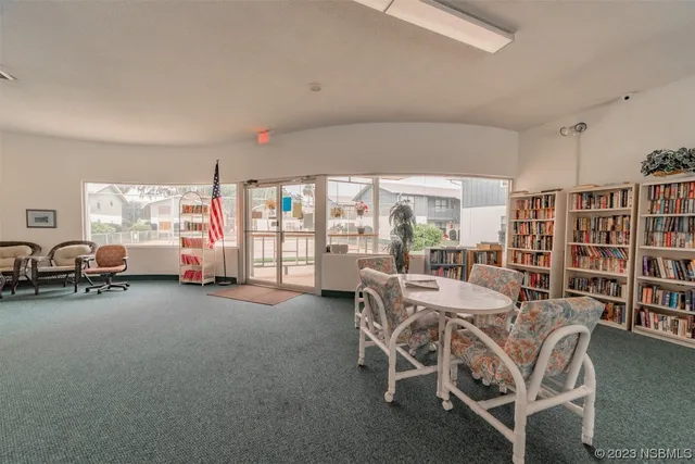 a dining room with furniture and a book shelf