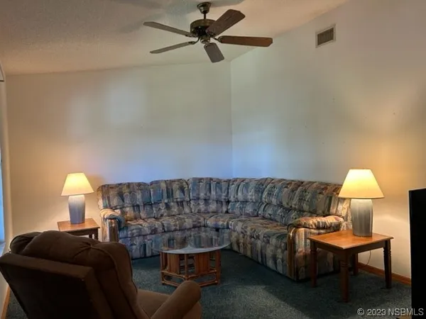 a living room with furniture a lamp and a lamp