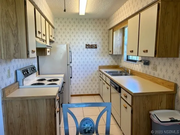 a kitchen with a sink a stove and a microwave