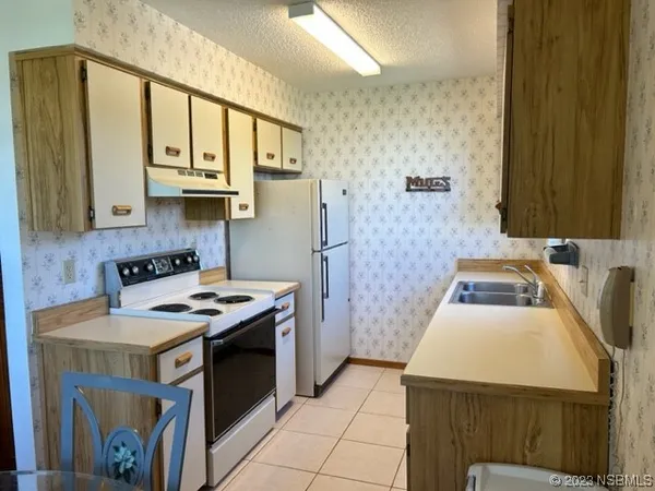 a kitchen that has a sink and a stove