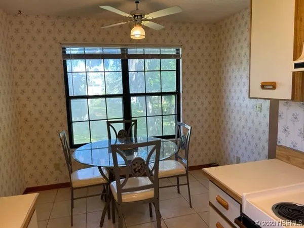a view of a dining room with furniture and a chandelier