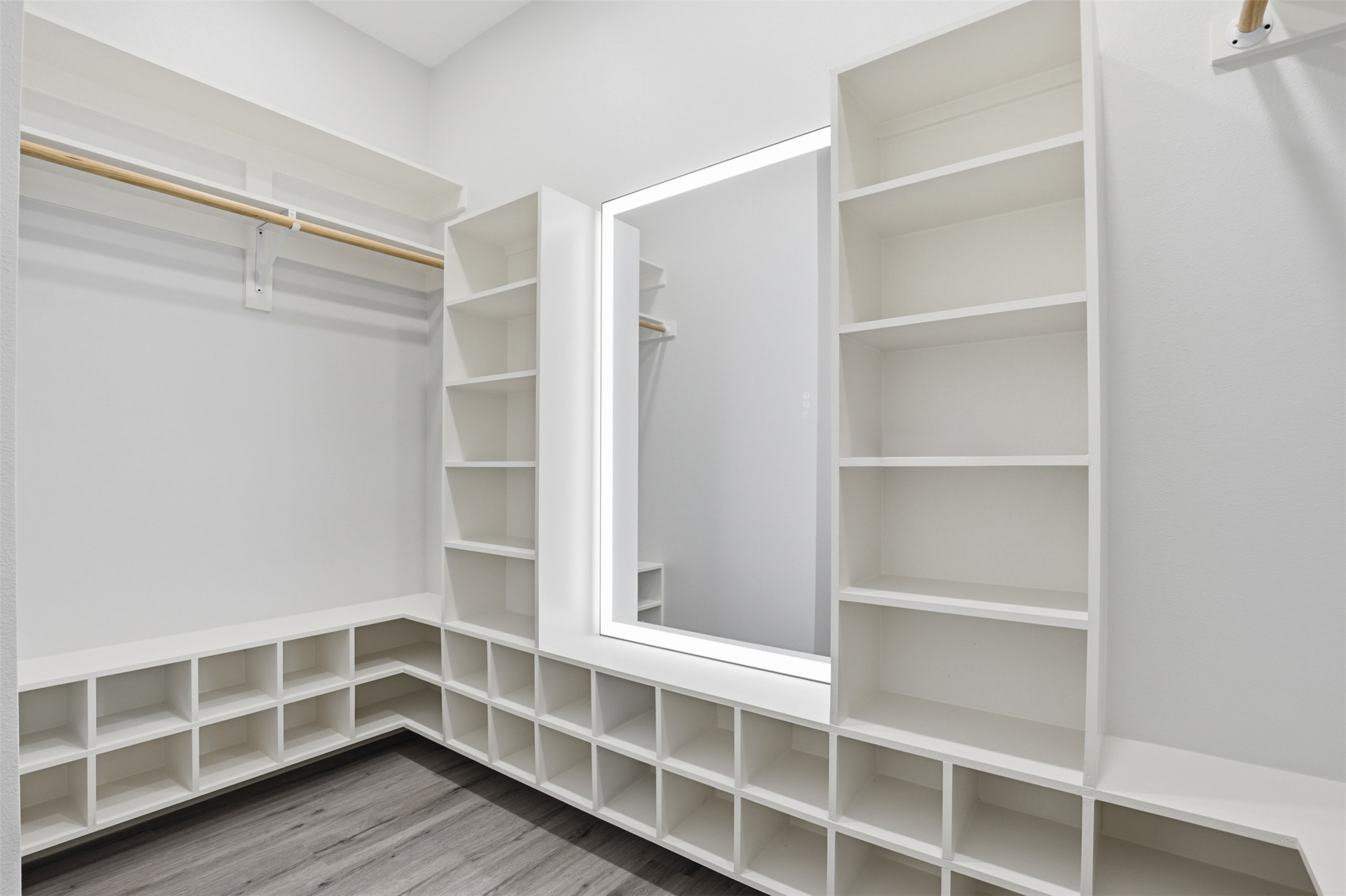 113 Los Robles Road Elgin, TX 78621 - Photo 9 of 20 Custom closet organization system featuring a full-height illuminated mirror, extensive shelving, integrated cubbies, and a hanging rod