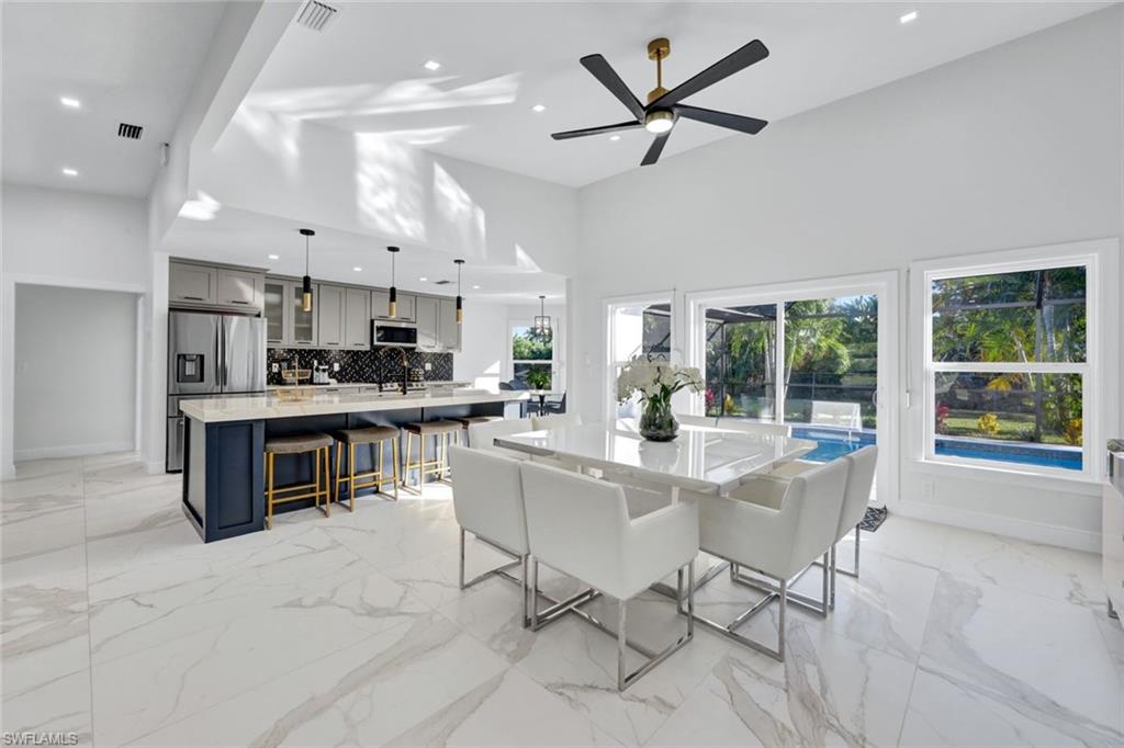 a view of kitchen with stainless steel appliances kitchen island island in the center