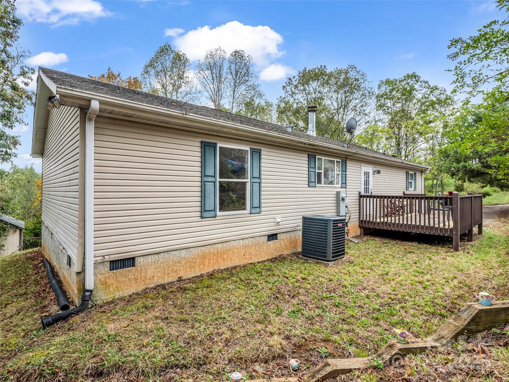 114 Leonards Lane Weaverville, NC 28787 - Photo 31 of 34 a view of a house with wooden deck and a yard