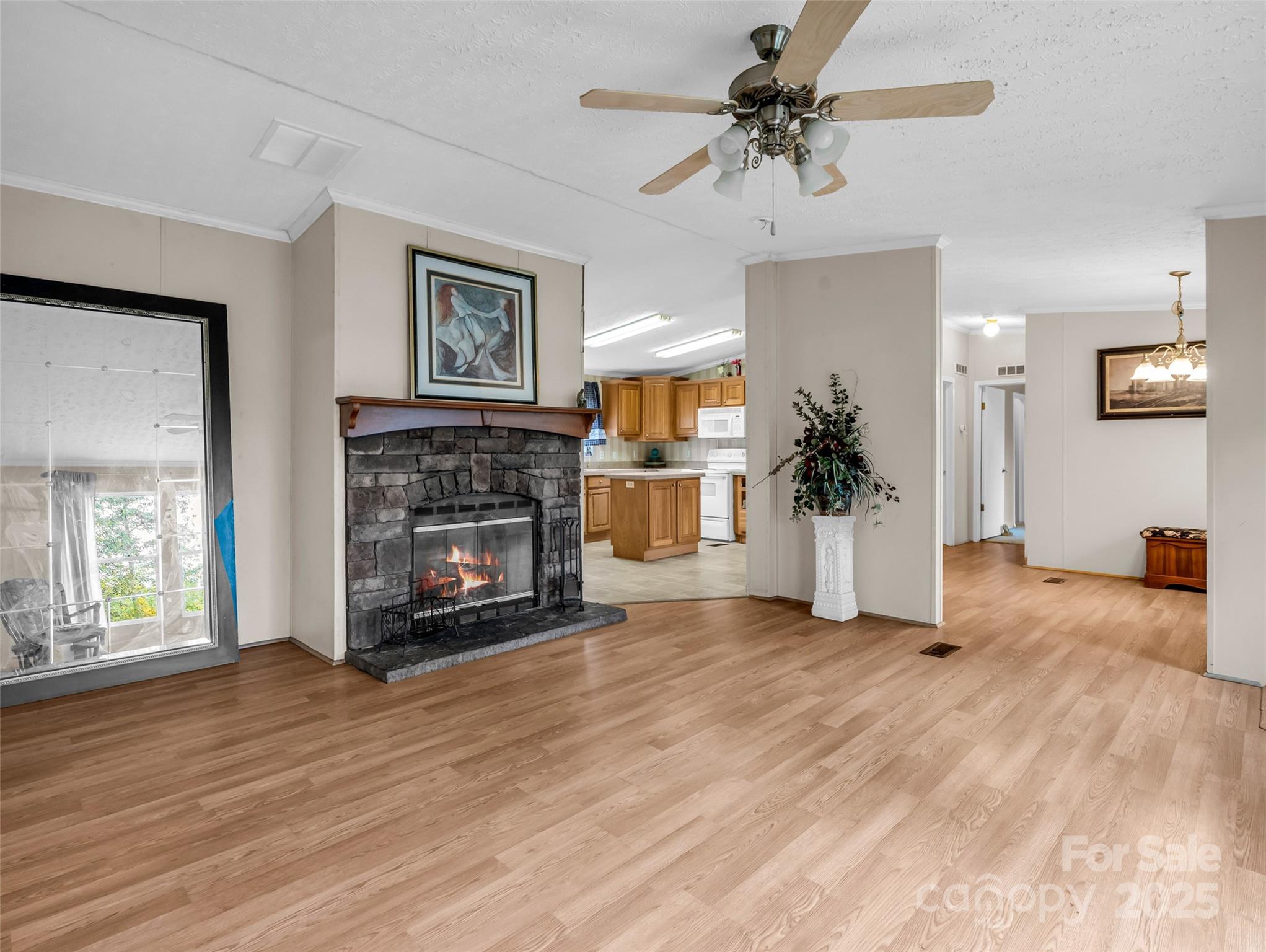 114 Leonards Lane Weaverville, NC 28787 - Photo 7 of 34 a view of a livingroom with a fireplace a ceiling fan and windows