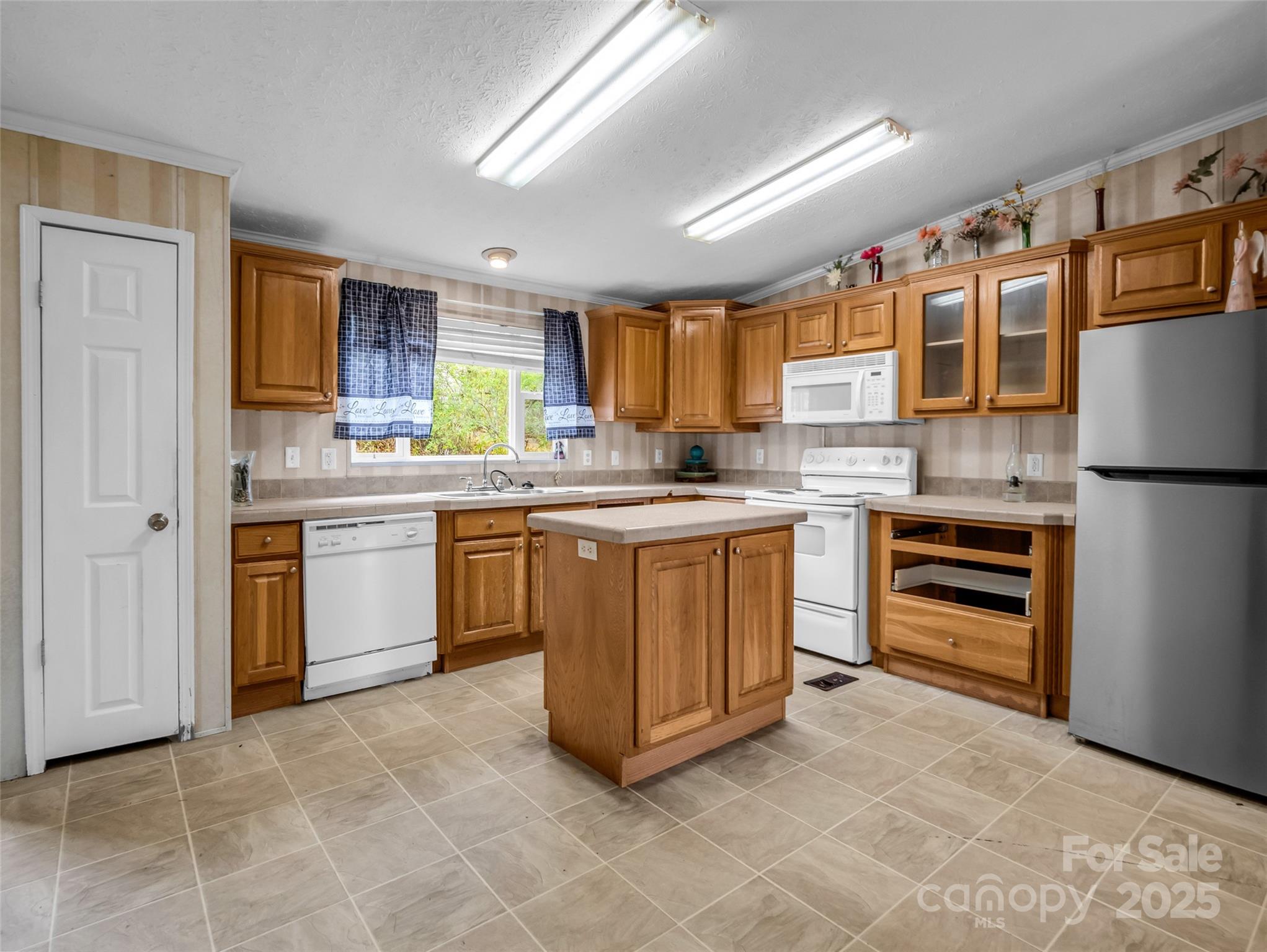 114 Leonards Lane Weaverville, NC 28787 - Photo 8 of 34 a kitchen with stainless steel appliances granite countertop a stove a sink and a refrigerator