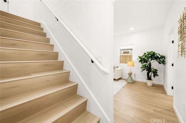 a dining room with furniture potted plants and wooden floor