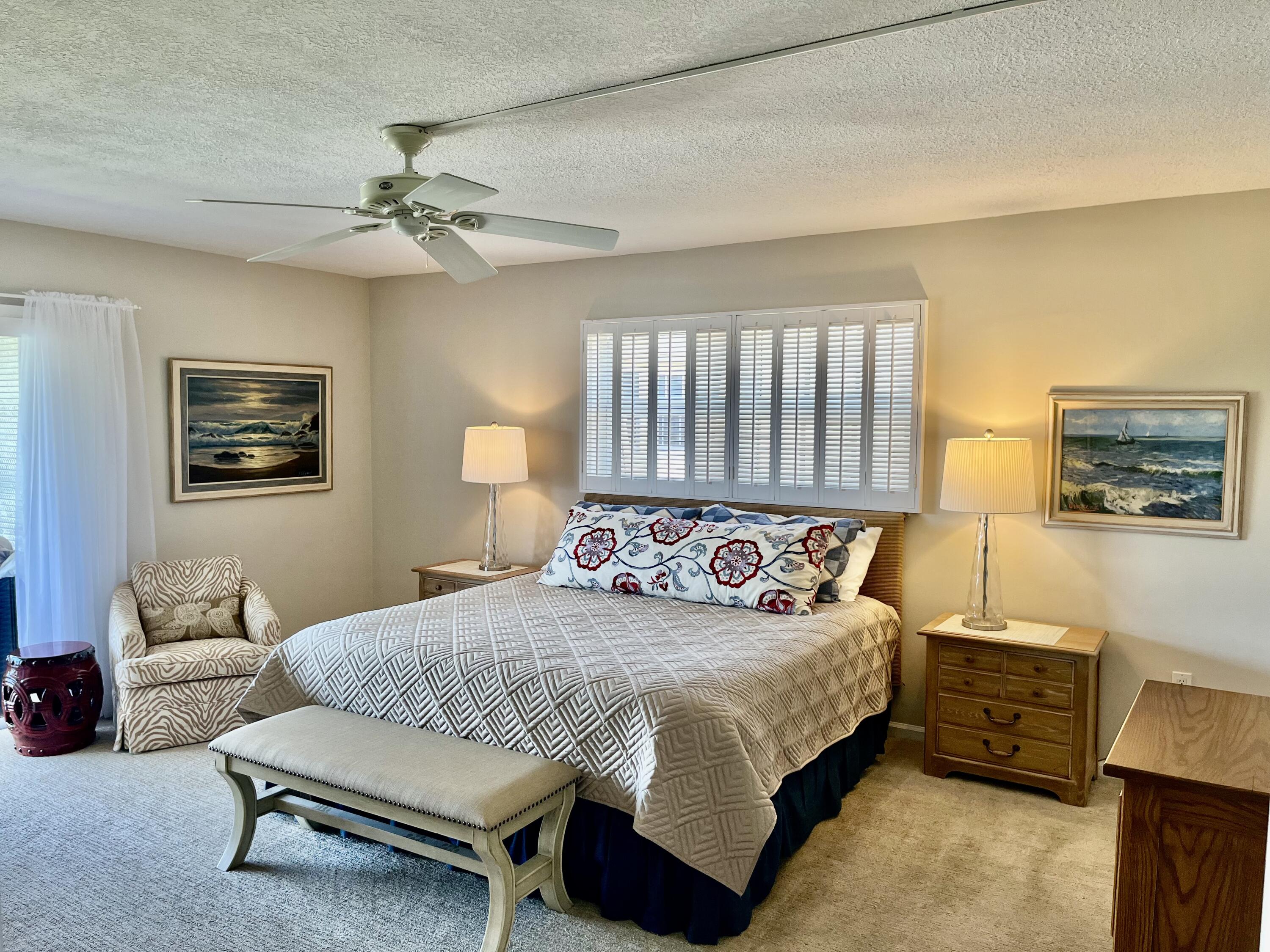 145 Atlantis Boulevard, Unit PH4 Atlantis, FL 33462 - Photo 12 of 27 a bedroom with a bed and a couch