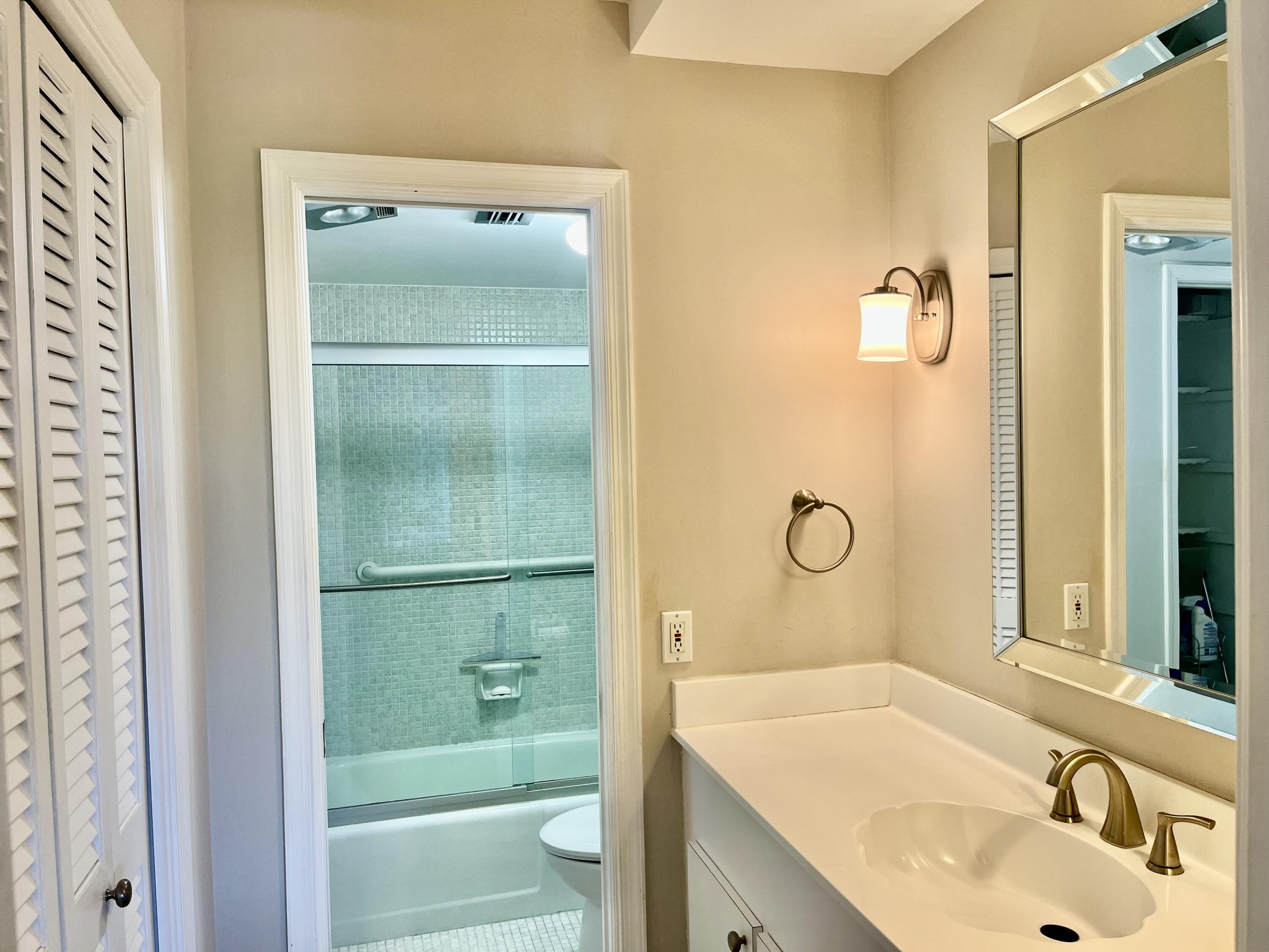 145 Atlantis Boulevard, Unit PH4 Atlantis, FL 33462 - Photo 14 of 27 a bathroom with a sink and a mirror