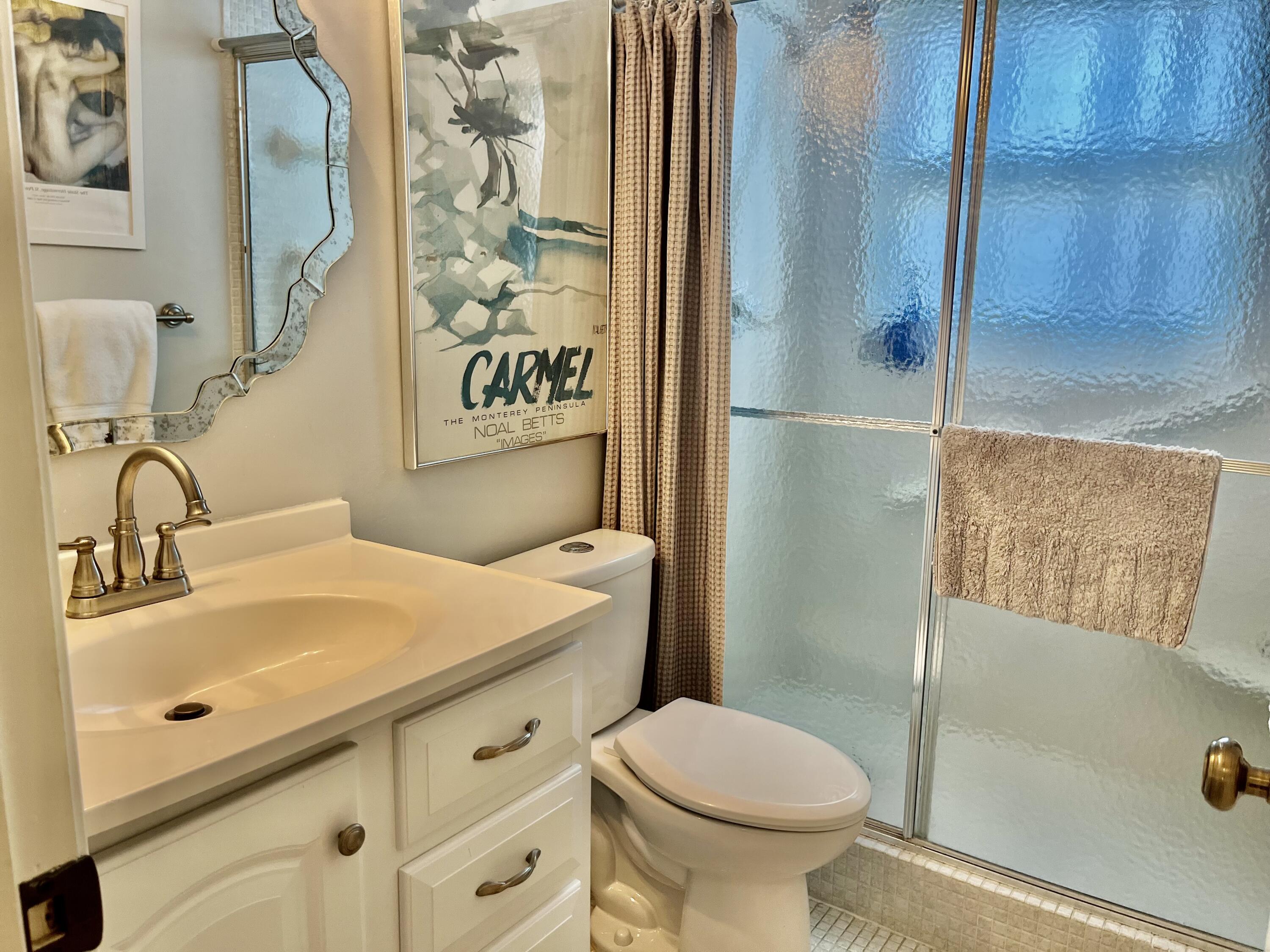 145 Atlantis Boulevard, Unit PH4 Atlantis, FL 33462 - Photo 16 of 27 a bathroom with a sink toilet and shower