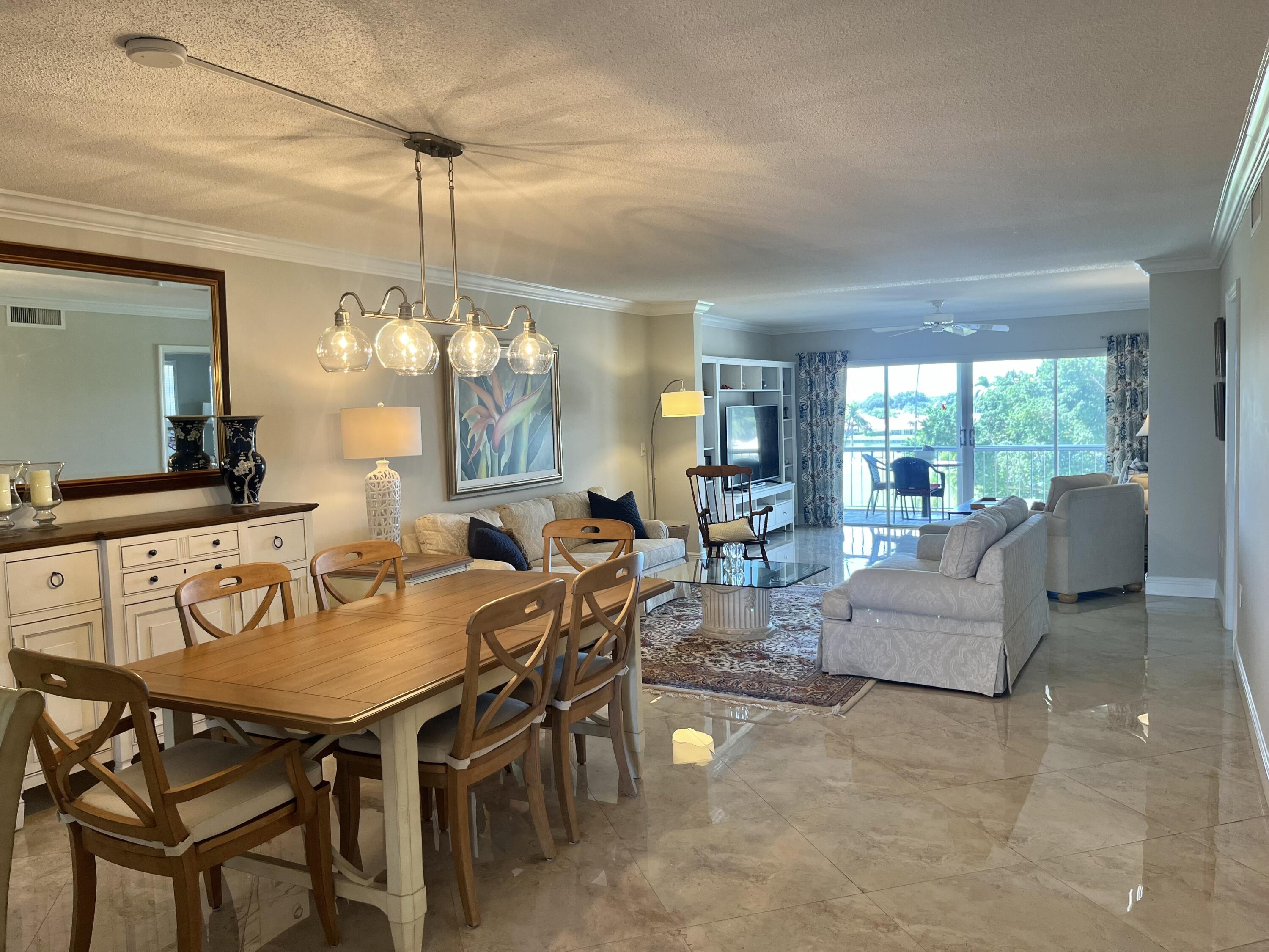 145 Atlantis Boulevard, Unit PH4 Atlantis, FL 33462 - Photo 2 of 27 a view of a dining room with furniture window and outside view