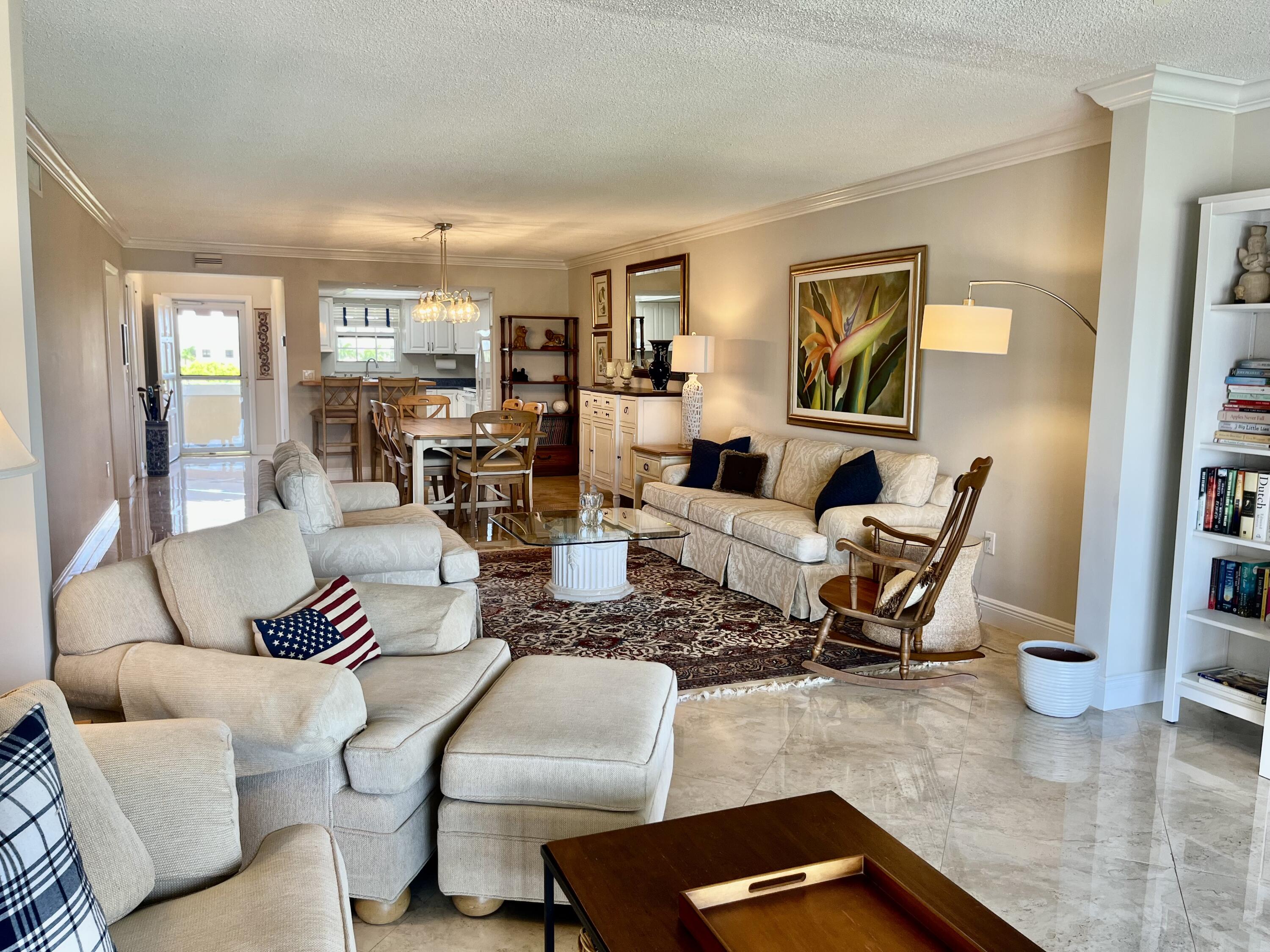 145 Atlantis Boulevard, Unit PH4 Atlantis, FL 33462 - Photo 10 of 27 a living room with furniture or couch and a wooden floor