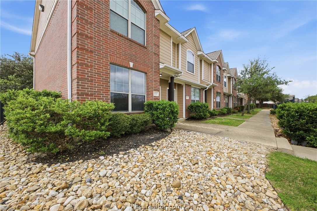 1000 Spring Loop, Unit 2105 College Station, TX 77840 - Photo 19 of 22 a view of a building with a yard