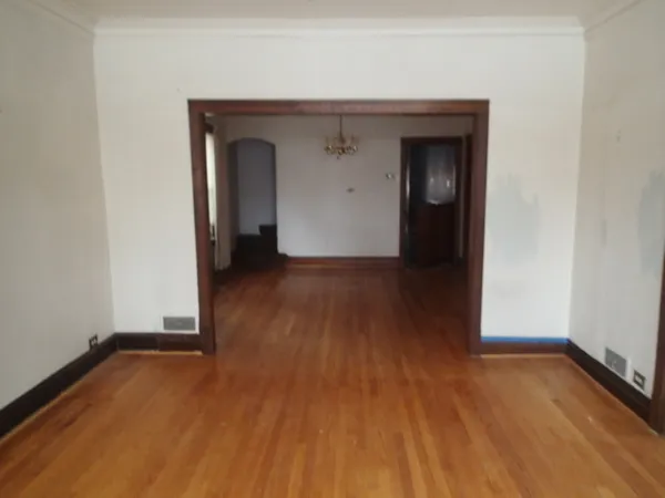 an empty room with wooden floor and closet