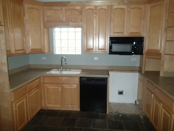 a kitchen with a sink and a microwave