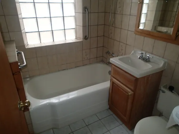 a white bath tub sitting next to a white sink
