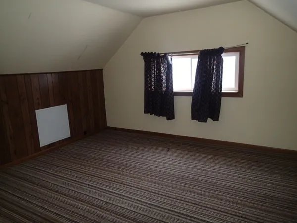 a view of wooden floor and windows in a room
