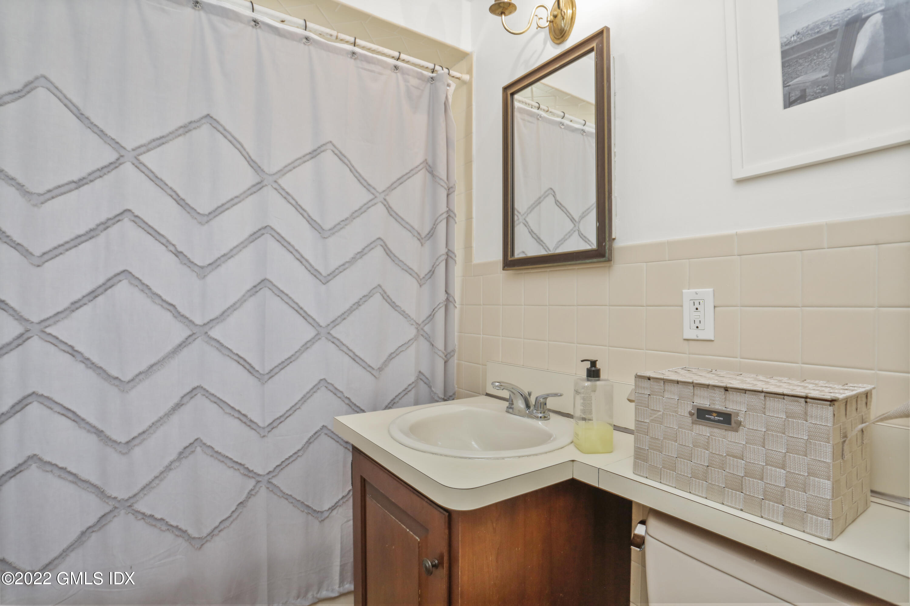 89 Hendrie Avenue Riverside, CT 06878 - Photo 23 of 36 a bathroom with a sink and a mirror