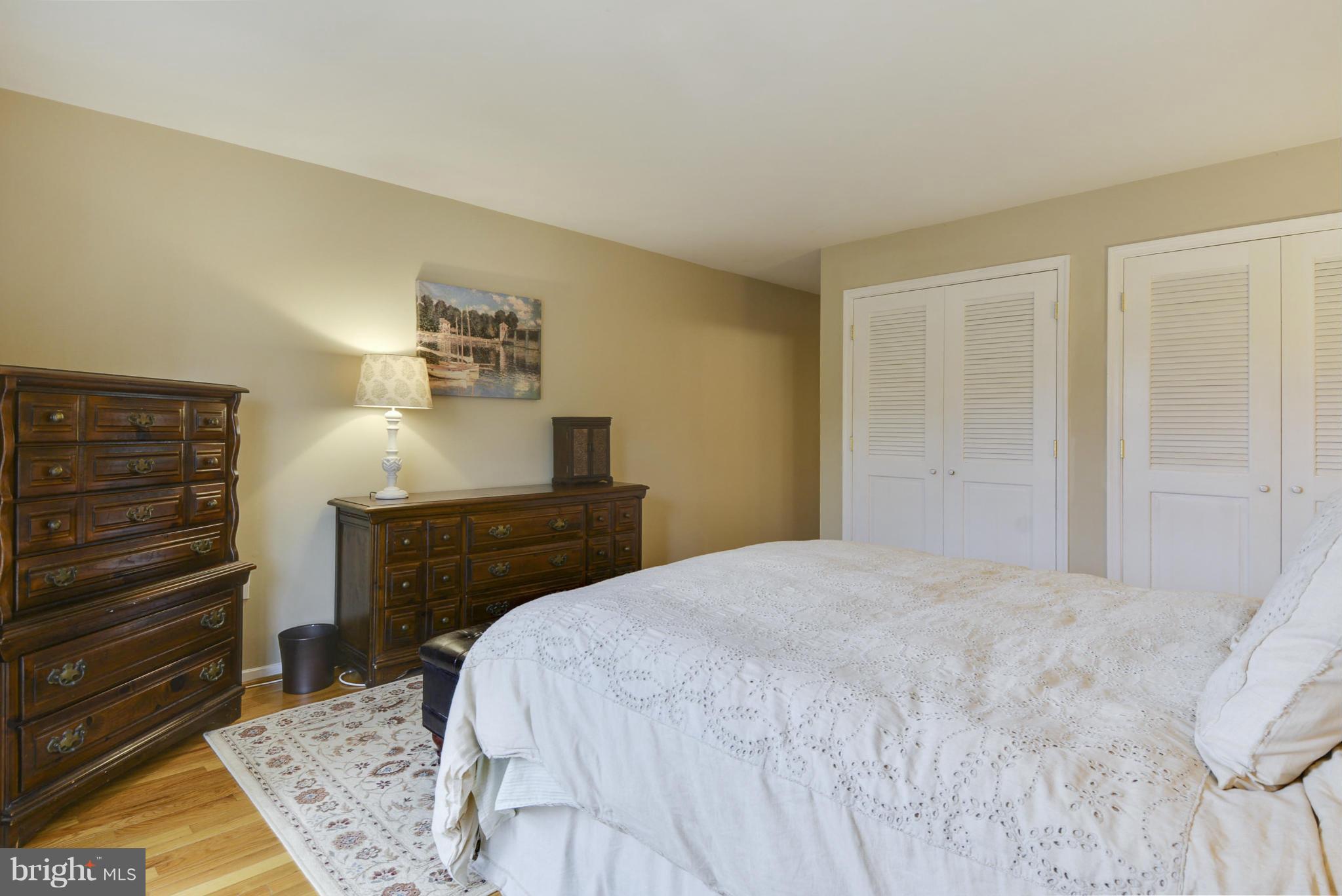 11706 Indian Ridge Road Reston, VA 20191 - Photo 13 of 30 a bedroom with a bed and cabinets