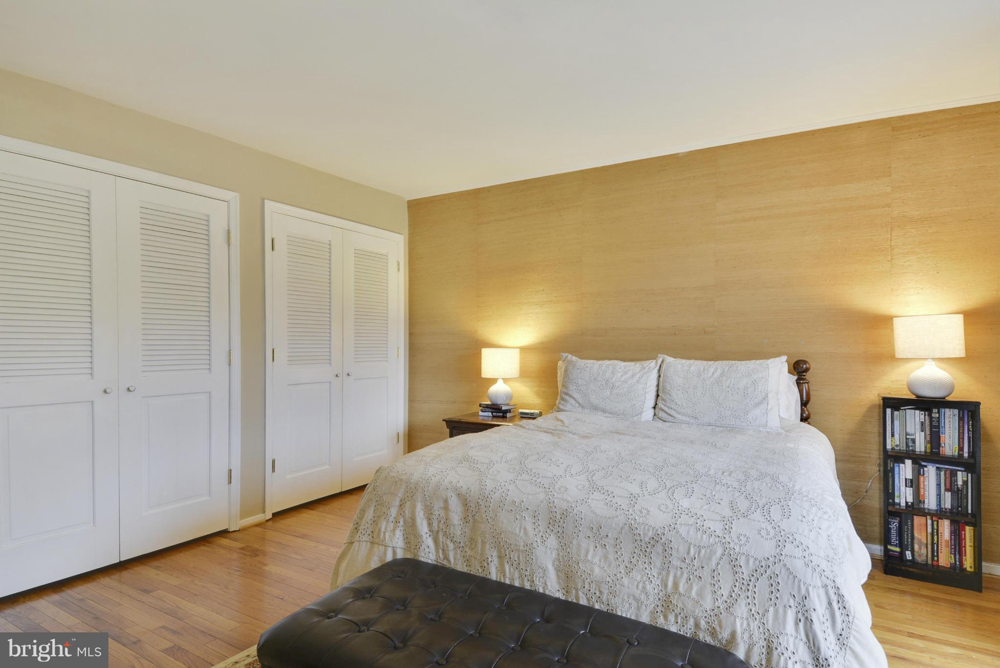 11706 Indian Ridge Road Reston, VA 20191 - Photo 14 of 30 a spacious bedroom with a bed and a lamp on table