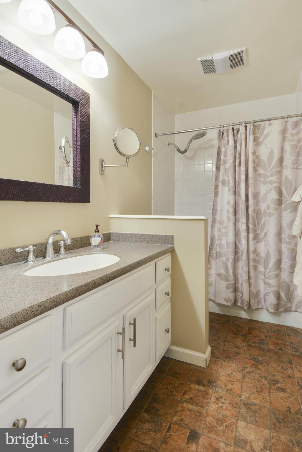 11706 Indian Ridge Road Reston, VA 20191 - Photo 15 of 30 a bathroom with a double vanity sink and a mirror