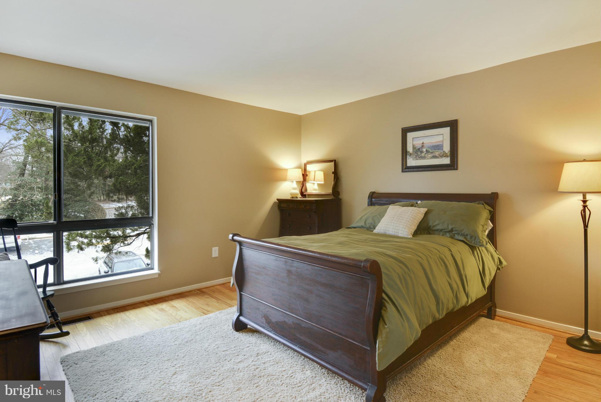 11706 Indian Ridge Road Reston, VA 20191 - Photo 20 of 30 a bedroom with a bed and wooden floor