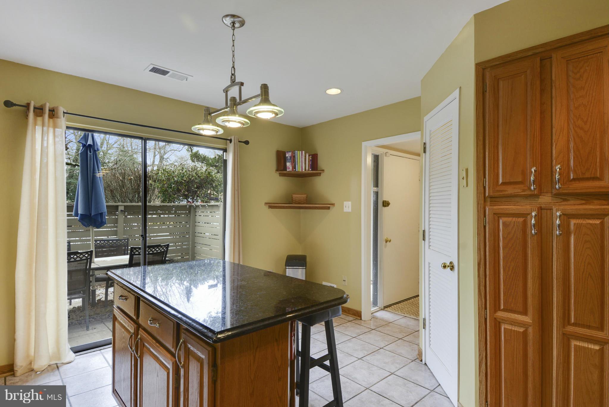 11706 Indian Ridge Road Reston, VA 20191 - Photo 4 of 30 a kitchen that has a kitchen island wooden cabinets and stainless steel appliances