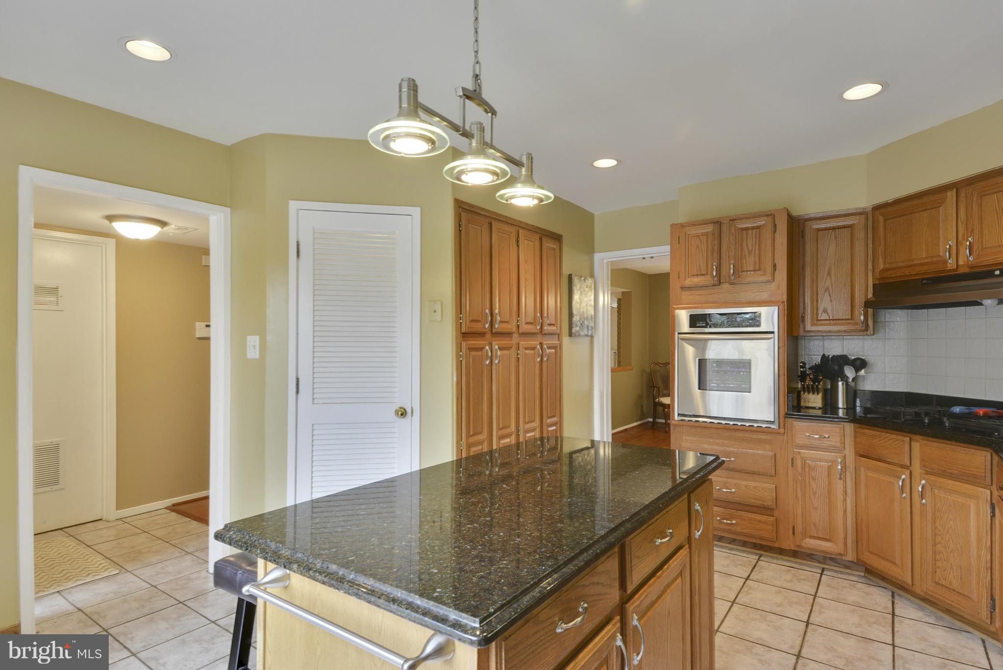 11706 Indian Ridge Road Reston, VA 20191 - Photo 5 of 30 a kitchen with stainless steel appliances granite countertop a sink refrigerator and cabinets