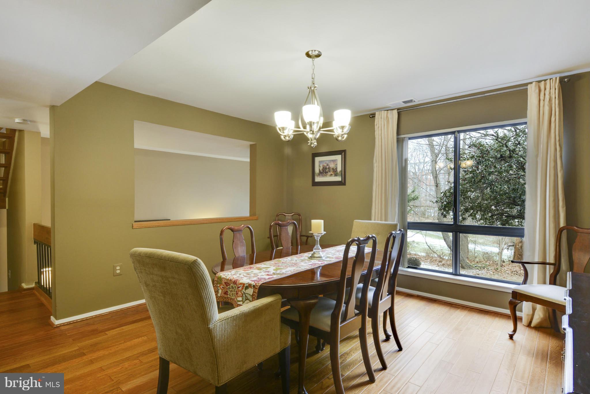 11706 Indian Ridge Road Reston, VA 20191 - Photo 7 of 30 a view of a dining room with furniture wooden floor and chandelier