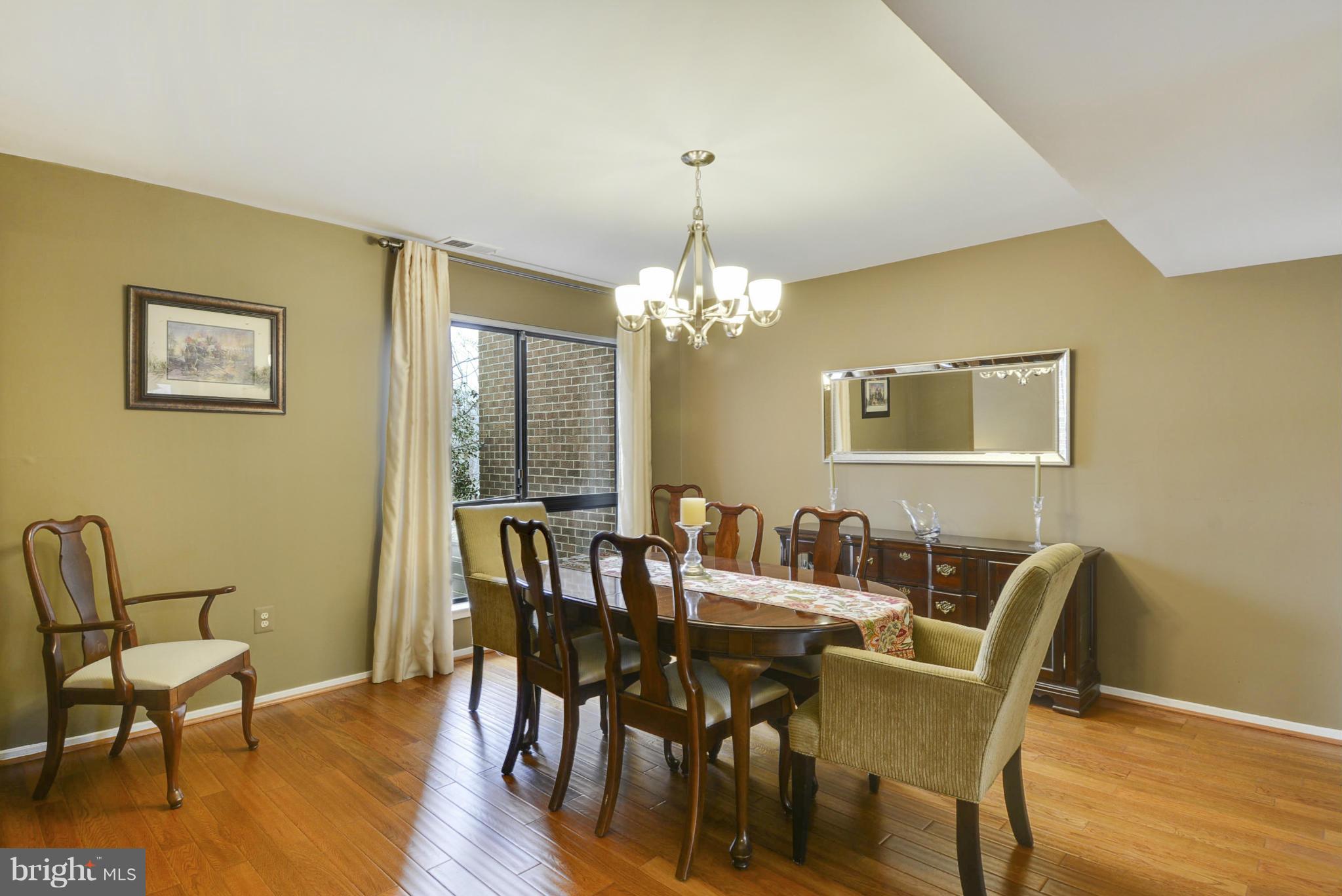 11706 Indian Ridge Road Reston, VA 20191 - Photo 8 of 30 a view of a dining room with furniture and wooden floor