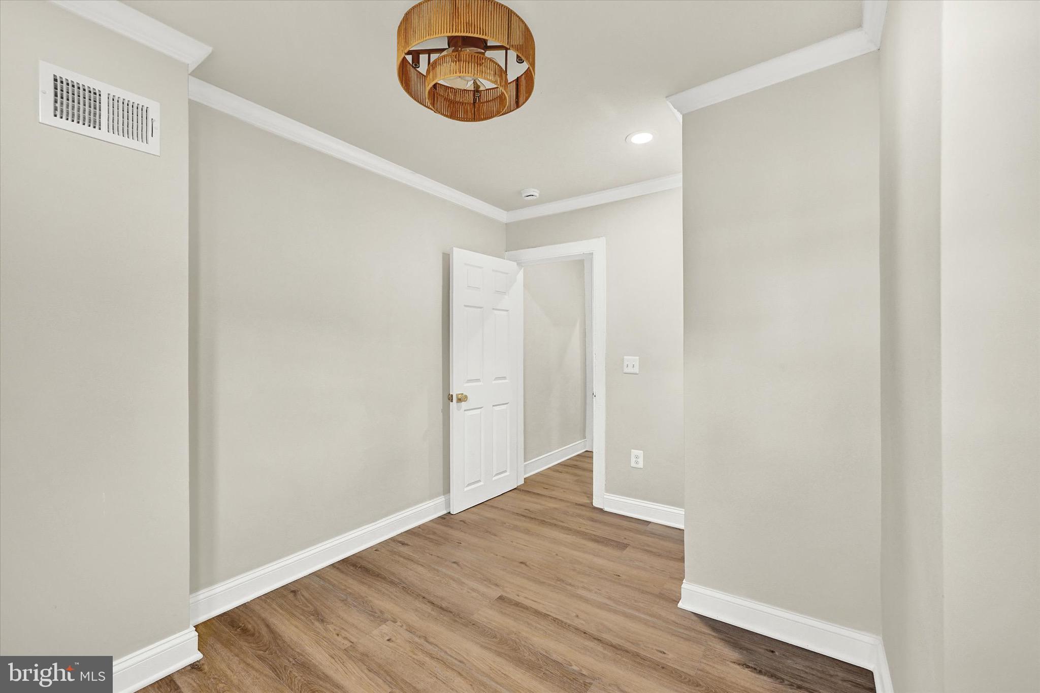 1304 Rutter Street Baltimore, MD 21217 - Photo 18 of 26 a view of an empty room with wooden floor