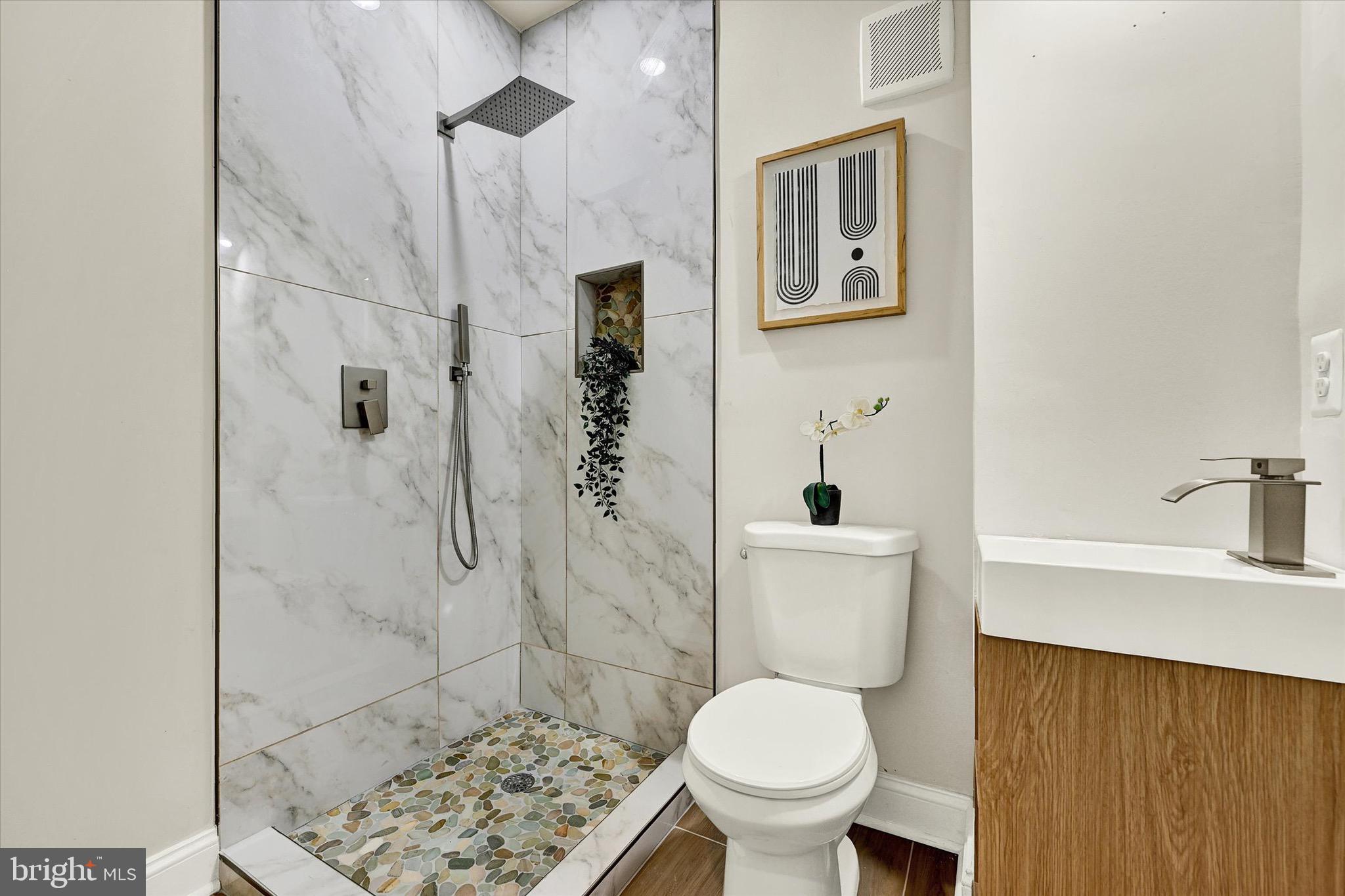 1304 Rutter Street Baltimore, MD 21217 - Photo 20 of 26 a bathroom with a toilet sink and shower