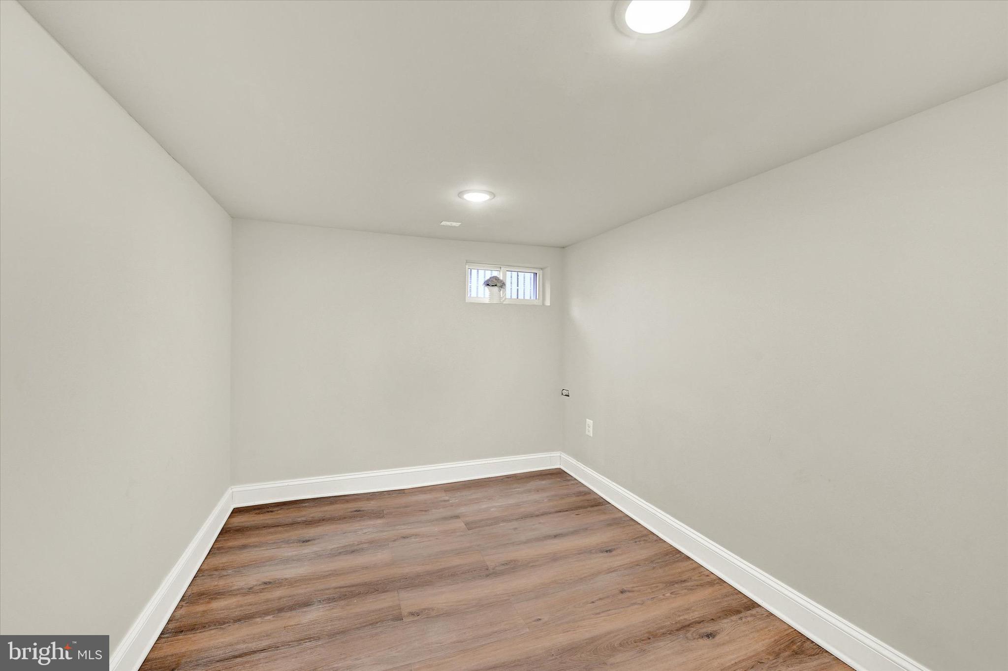 1304 Rutter Street Baltimore, MD 21217 - Photo 21 of 26 a view of a big room with wooden floor and windows