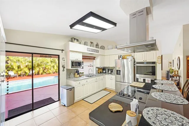 a kitchen with a stove a sink and a refrigerator
