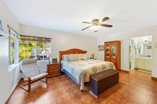 a spacious bedroom with a bed and a chandelier