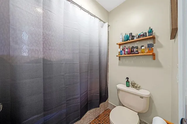 a white toilet sitting next to a bathroom sink