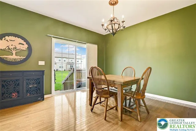a view of a dining room with furniture and a chandelier