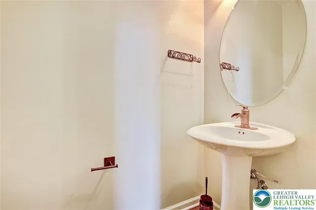 a bathroom with a sink a mirror and vanity