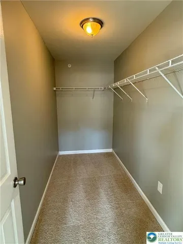 a view of a room with racks on the wall and a window