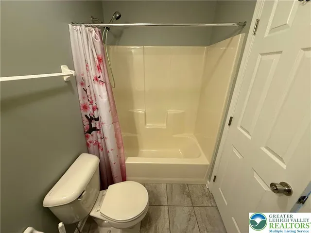 a bathroom with a toilet and shower