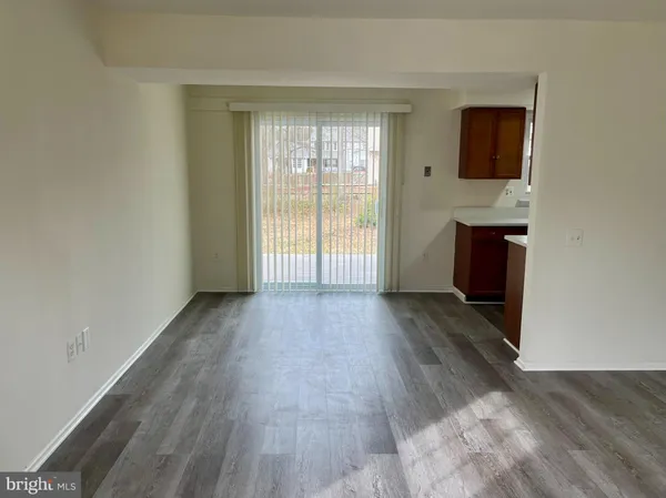 a view of a livingroom with wooden floor and a window